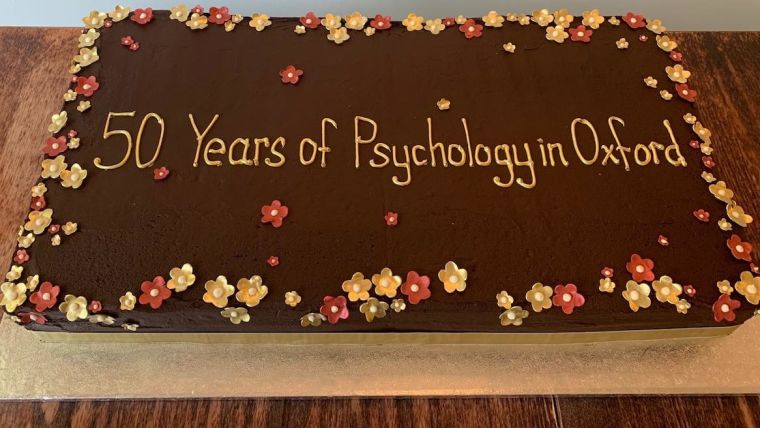 Photo of chocolate cake with words, "50 Years of Psychology in Oxford."